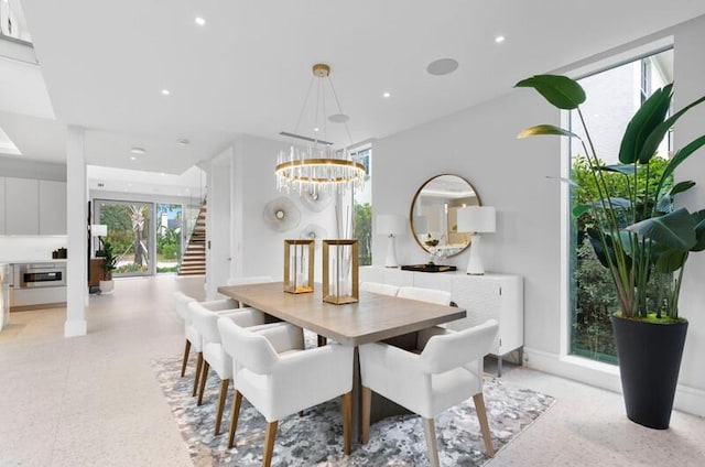 260 31st St, West Palm Beach, FL 33407 - dining space with a chandelier, stairway, dark speckled floor, and recessed lighting