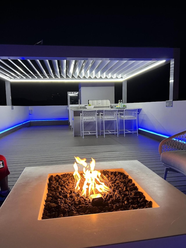 exterior space featuring a fire pit and area for grilling