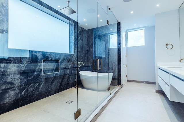 full bathroom with a soaking tub, recessed lighting, a marble finish shower, and vanity