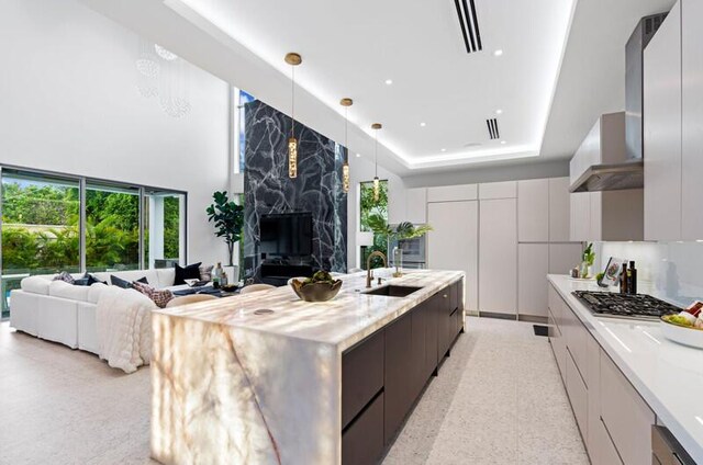 260 31st St, West Palm Beach, FL 33407 - kitchen with modern cabinets, a sink, light countertops, a towering ceiling, and recessed lighting