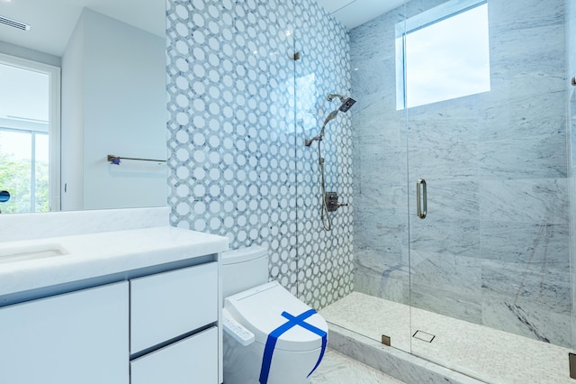 bathroom featuring toilet, a shower stall, visible vents, and vanity