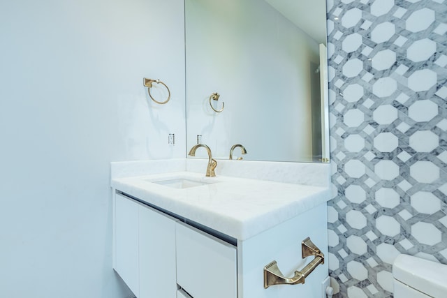 half bathroom featuring toilet and vanity