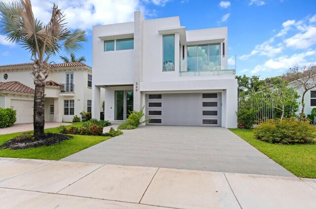 260 31st St, West Palm Beach, FL 33407 - view of front of house with stucco siding, concrete driveway, and a garage