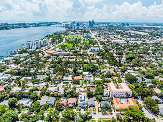 drone / aerial view featuring a view of city and a water view