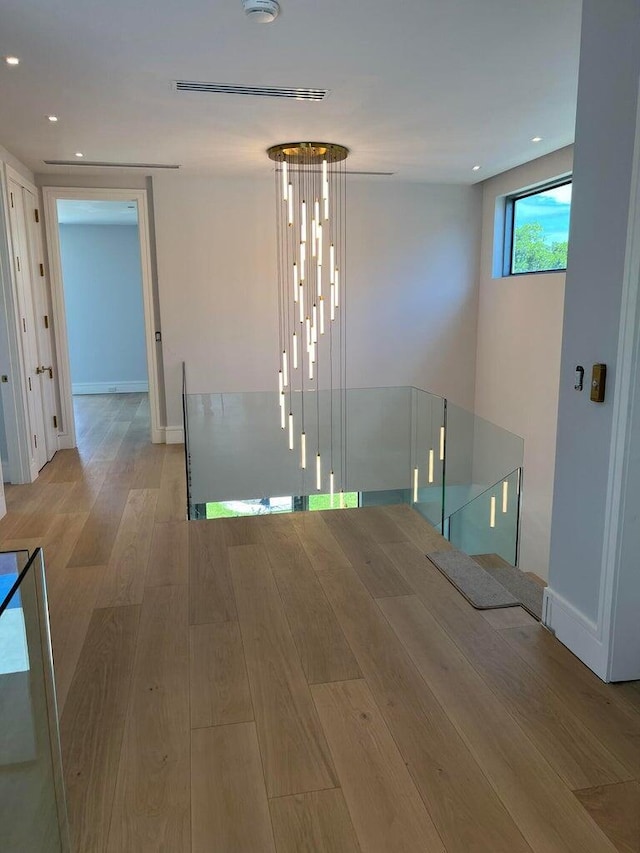 spare room with stairway, recessed lighting, wood finished floors, and baseboards