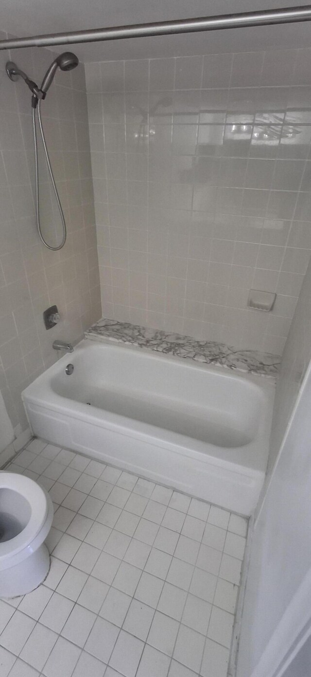 full bathroom featuring vanity, toilet, tiled shower / bath, and tile patterned floors