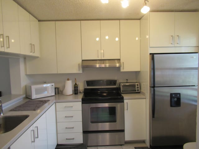 kitchen featuring white cabinetry, appliances with stainless steel finishes, and sink