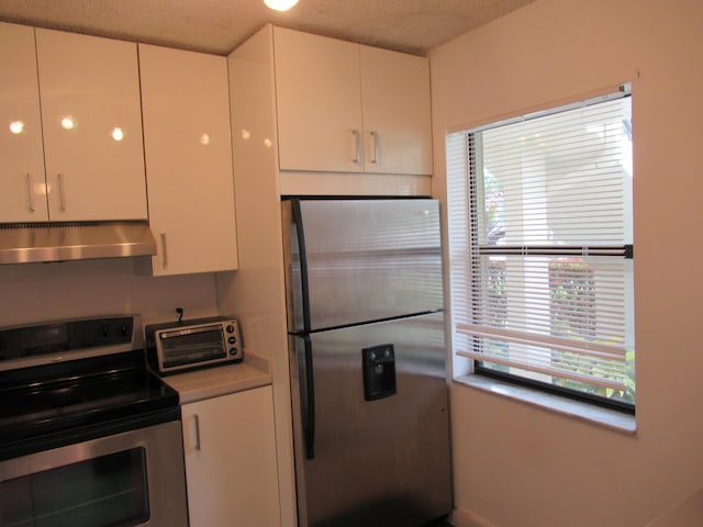 kitchen with white cabinets and appliances with stainless steel finishes