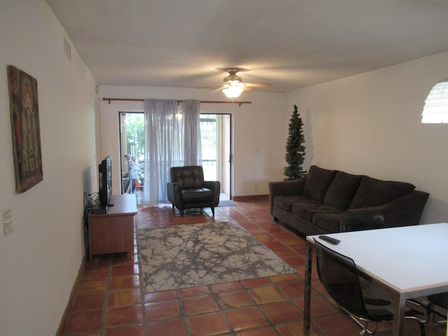 tiled living room with ceiling fan