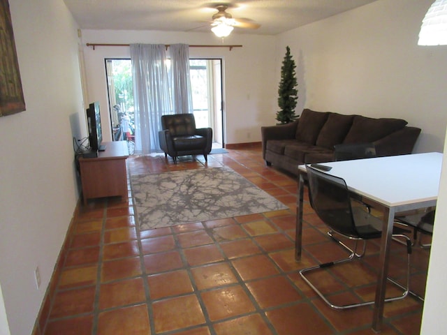 tiled living room with ceiling fan