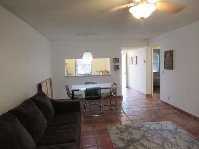 tiled living room featuring ceiling fan