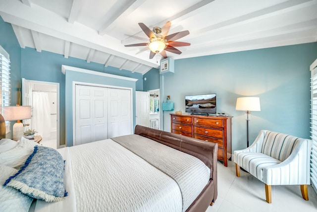 bedroom with a closet, ceiling fan, vaulted ceiling with beams, and multiple windows