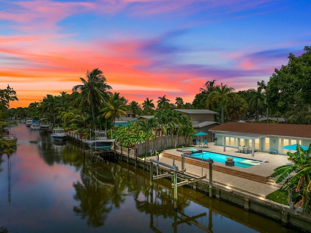 exterior space with a water view and a patio