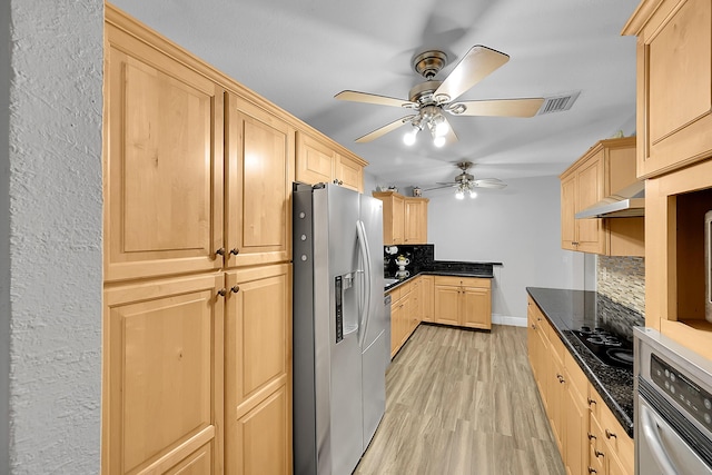 602 SE 6th Ave, Deerfield Beach, FL 33441 - kitchen with backsplash, stainless steel appliances, light brown cabinets, dark stone counters, and light wood-type flooring
