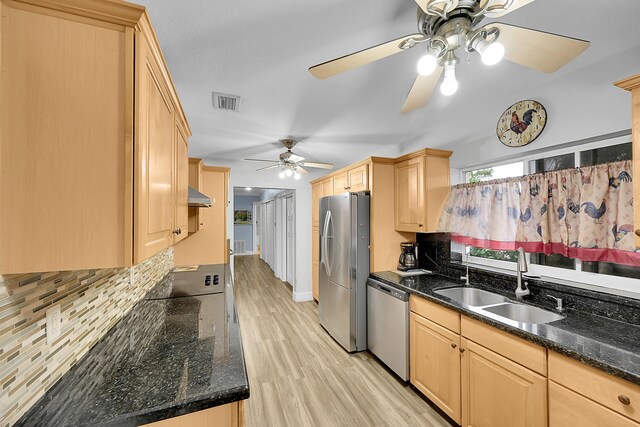 602 SE 6th Ave, Deerfield Beach, FL 33441 - kitchen with light brown cabinetry, sink, light hardwood / wood-style flooring, dark stone countertops, and stainless steel appliances
