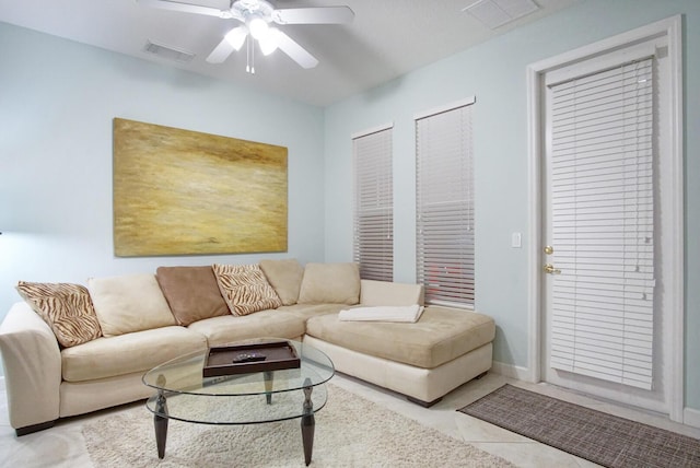 tiled living room with ceiling fan