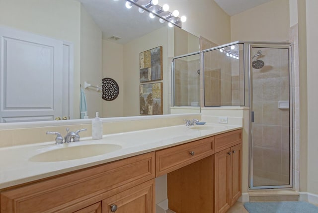 bathroom featuring an enclosed shower and vanity