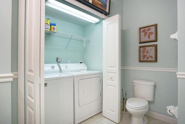 washroom with light tile patterned flooring and washing machine and clothes dryer