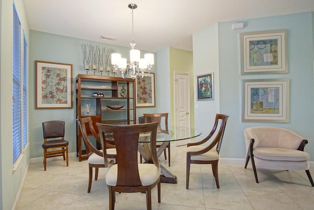 tiled dining space featuring an inviting chandelier