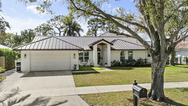 view of front of home featuring a garage and a front lawn