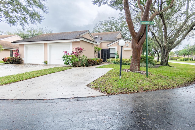 view of front facade featuring a front yard and a garage