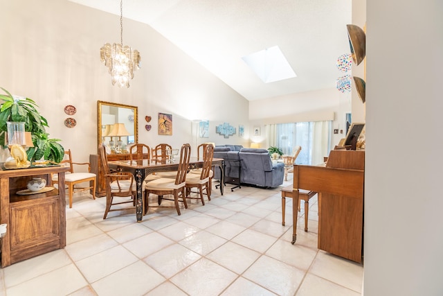 tiled dining room featuring an inviting chandelier and vaulted ceiling with skylight