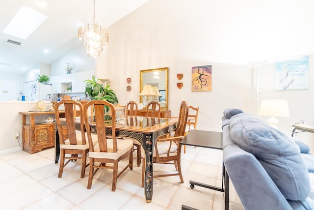 dining area featuring high vaulted ceiling, light tile patterned floors, a skylight, and a chandelier