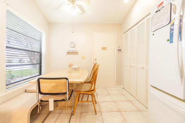 dining area with light tile patterned floors and ceiling fan