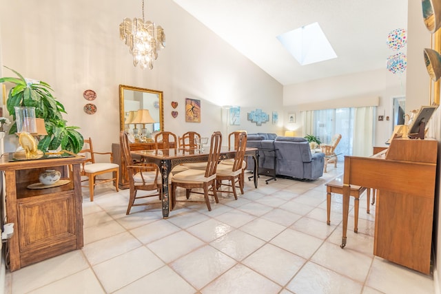 dining area with high vaulted ceiling, an inviting chandelier, light tile patterned floors, and a skylight