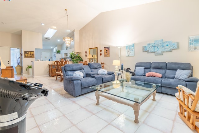 tiled living room featuring a notable chandelier, a skylight, and high vaulted ceiling