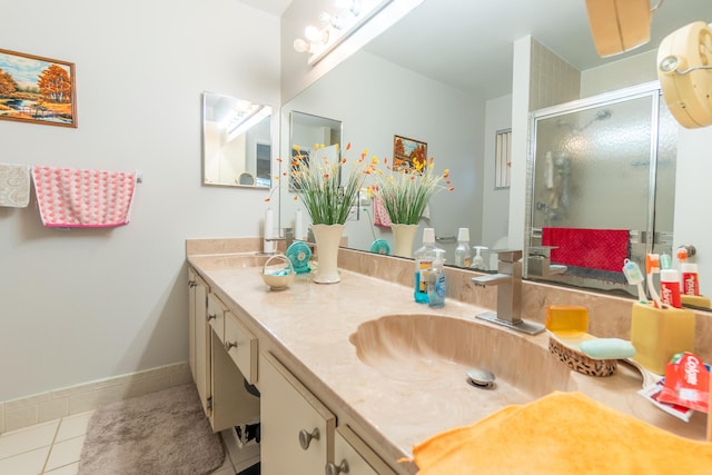 bathroom with vanity, tile patterned floors, and a shower with door