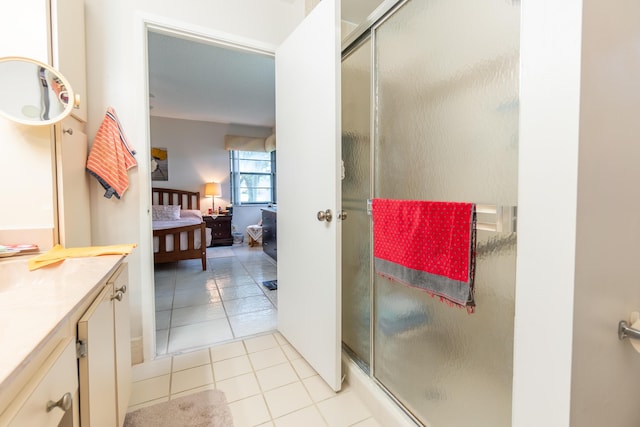 bathroom with tile patterned floors, an enclosed shower, and vanity