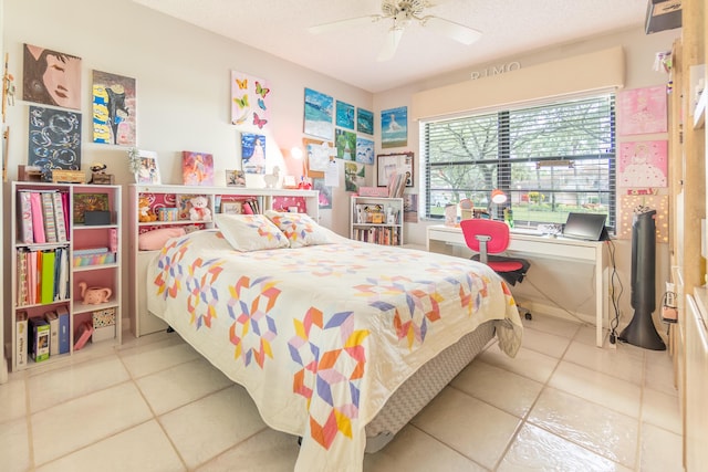 bedroom with ceiling fan, a textured ceiling, and tile patterned flooring