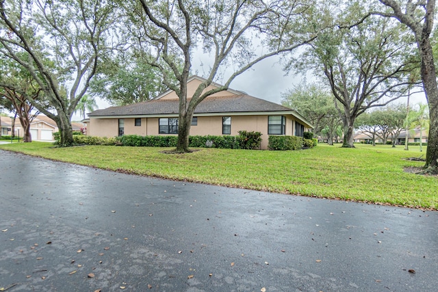 view of side of property with a yard