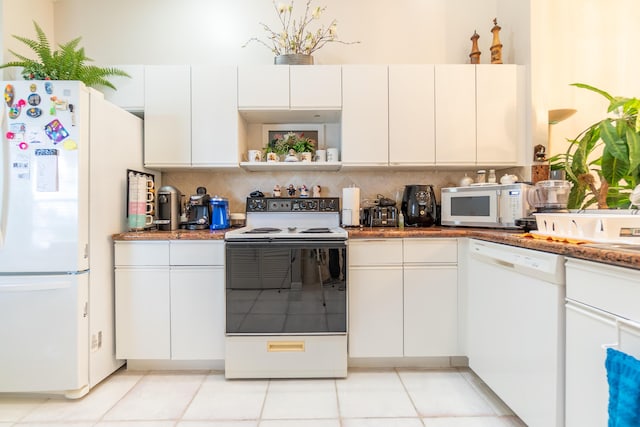 kitchen with white cabinetry, backsplash, and white appliances