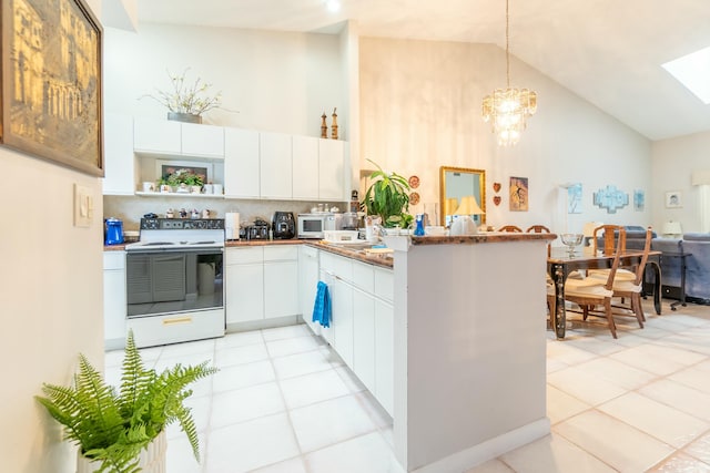 kitchen with kitchen peninsula, white appliances, white cabinetry, and pendant lighting