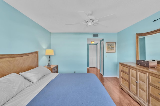 bedroom with ceiling fan and light hardwood / wood-style flooring