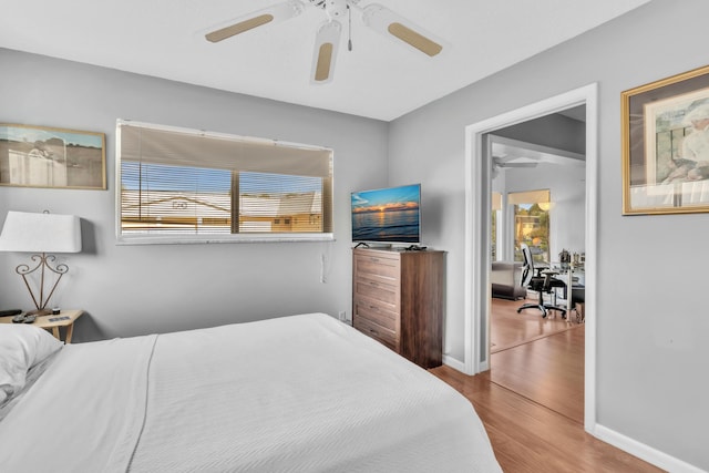 bedroom with wood-type flooring and ceiling fan