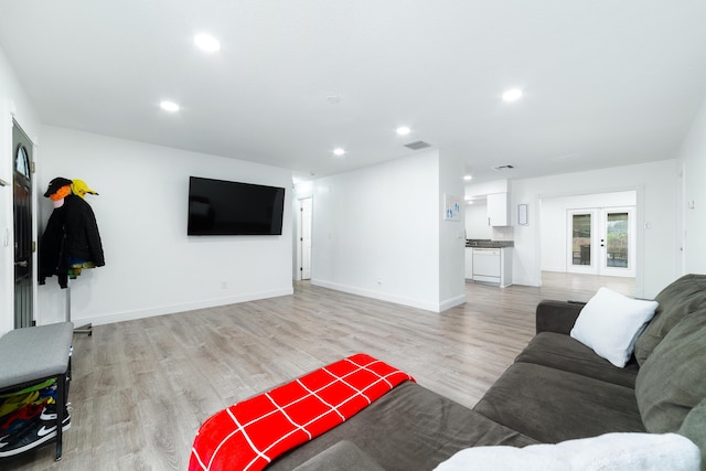 living room featuring french doors and light wood-type flooring