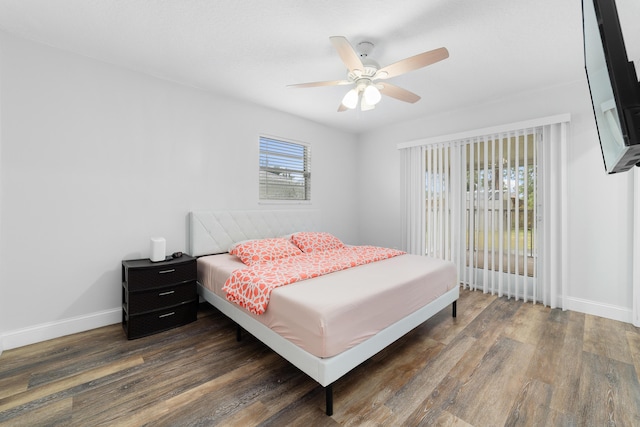 bedroom with dark hardwood / wood-style floors and ceiling fan