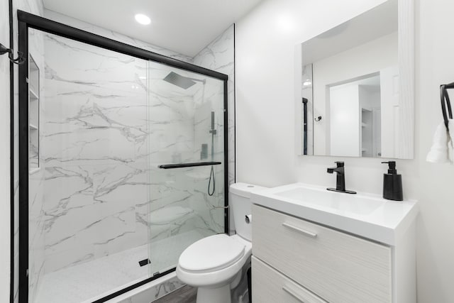 bathroom with vanity, toilet, and an enclosed shower