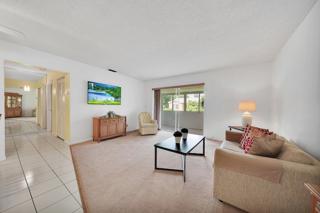 living room featuring light tile patterned floors and a textured ceiling