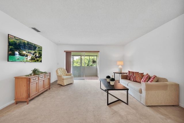 living room with light colored carpet and a textured ceiling