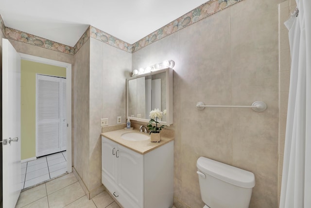 bathroom featuring vanity, toilet, and tile patterned flooring