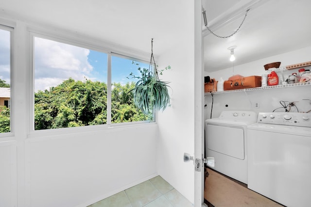 clothes washing area featuring independent washer and dryer and light tile patterned floors