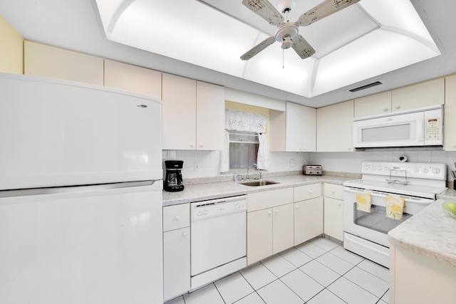 kitchen featuring tasteful backsplash, sink, light tile patterned floors, ceiling fan, and white appliances