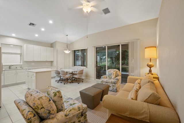 tiled living room with sink, vaulted ceiling, and ceiling fan