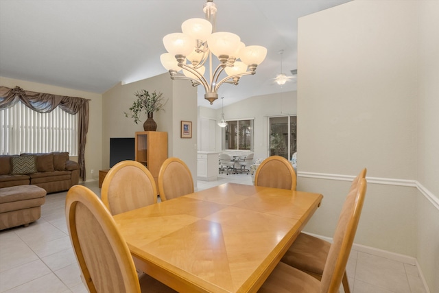 dining area featuring a chandelier, vaulted ceiling, and light tile patterned floors