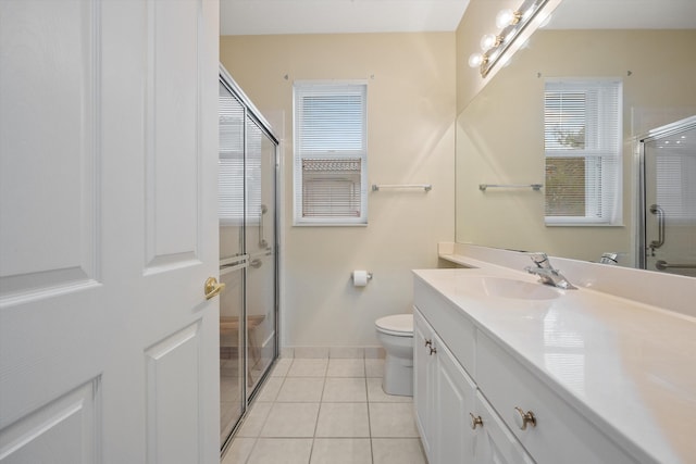 bathroom with vanity, toilet, a shower with door, and tile patterned flooring