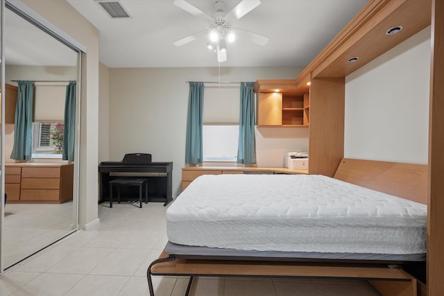 bedroom featuring ceiling fan and light tile patterned flooring